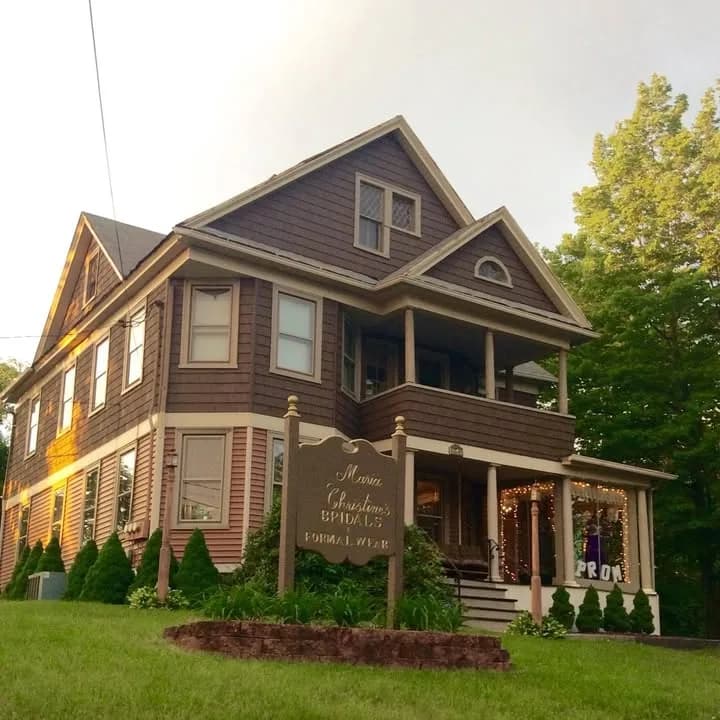 The shop: an old two-storey house with a porch and a sign on the lawn, on East Pearl Street in Torrington